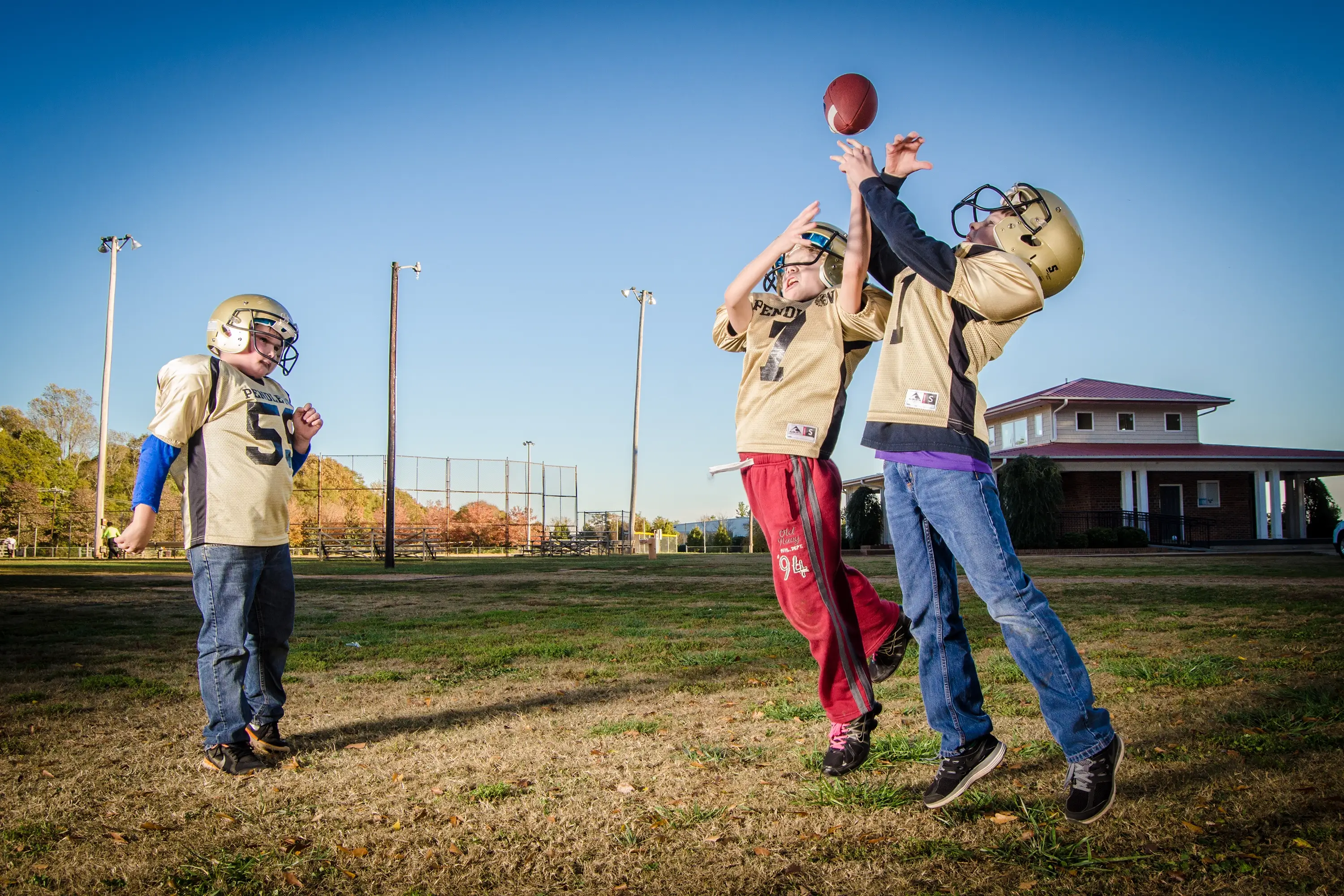 Kids playing football in the yard